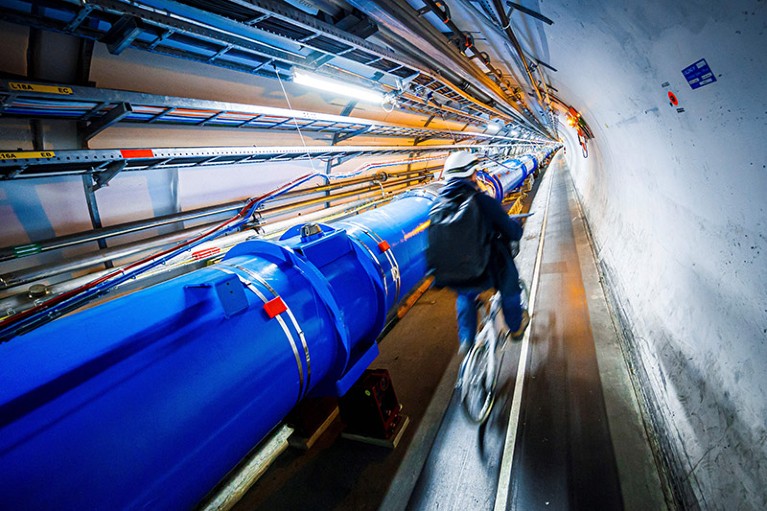 A man rides his bicycle along the beam line of the Large Hadron Collider (LHC) in a tunnel of the European Organisation for Nuclear Research (CERN), during maintenance works on February 6, 2020.A man rides his bicycle along the beam line of the Large Hadron Collider (LHC) in a tunnel of the European Organisation for Nuclear Research (CERN), during maintenance works on February 6, 2020.