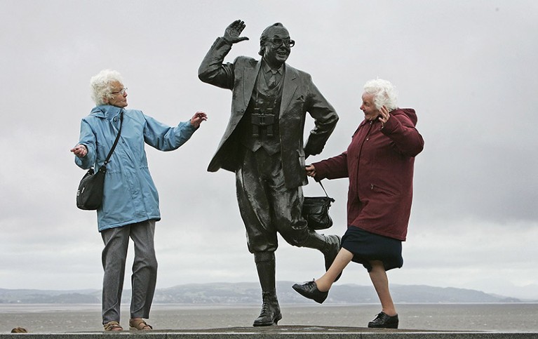 Pensioners raise a happy smile as they dance next to a statue of comedian Eric Morcambe, in Morcambe, England.