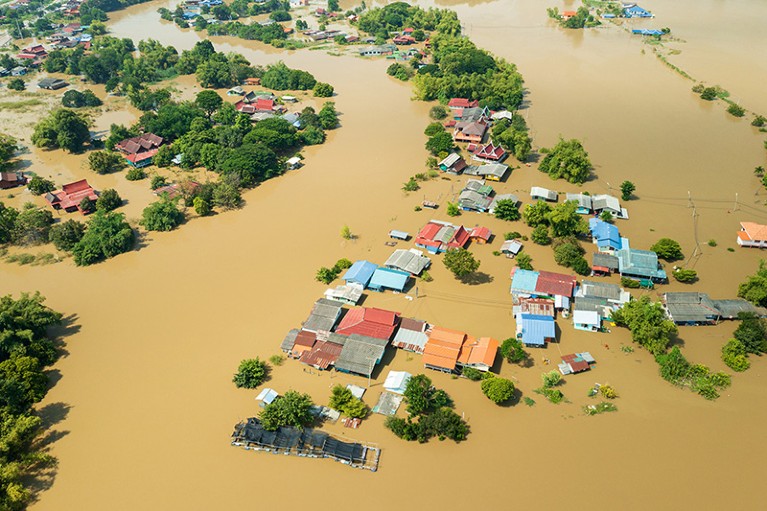 Houses and land part-submerged in brown flood water