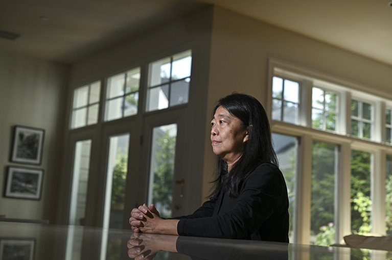 Vivian Cheung, a physician, professor and prominent researcher, is sitting in her home at a table.