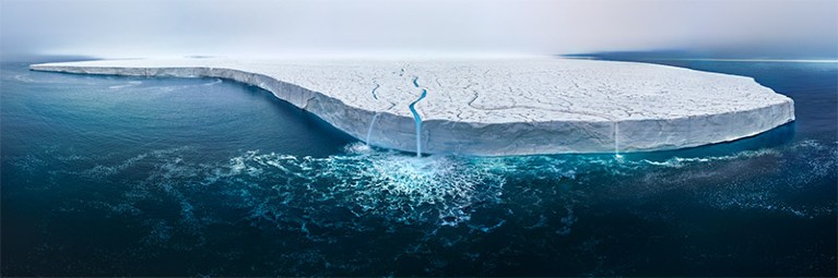 wide-angle shot of a huge flat topped icecap with meltwater forming rivulets and waterfalls cascading into the sea