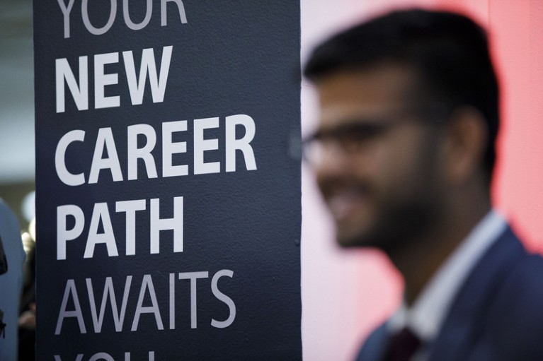 A sign reading "New Career Path Awaits" is displayed during the TechFair LA career fair