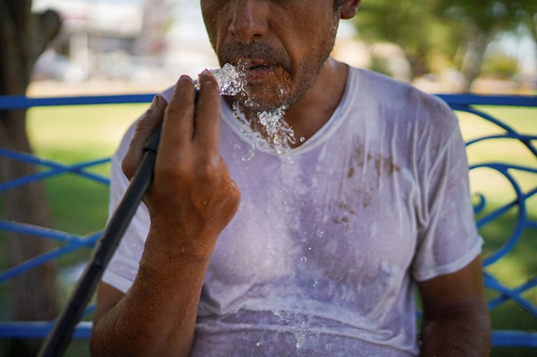 A man cools himself off with water from a hose at a park during the ongoing heatwave in Mexicali, Mexico in 2023.