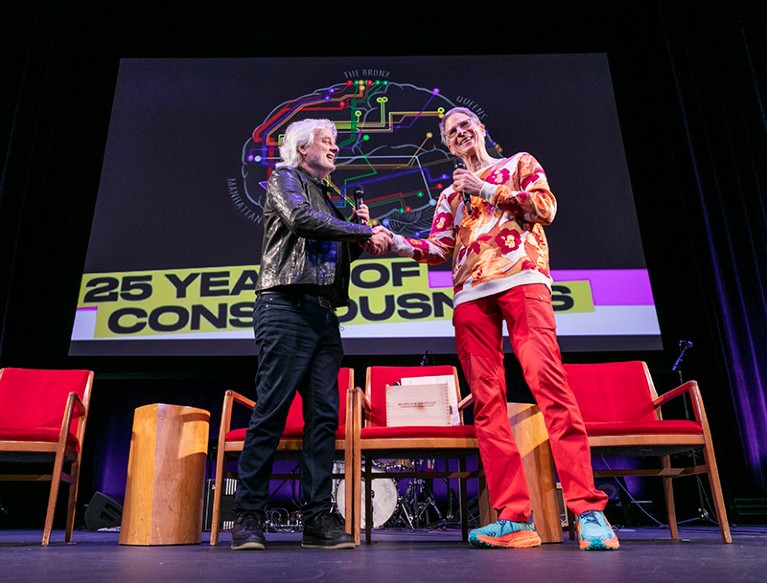 David Chalmers shakes hands with Christof Koch onstage at the Association for the Scientific Study of Consciousness meet