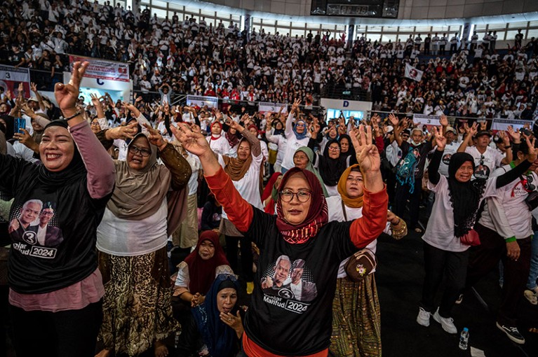 Supporters of presidential candidate Ganjar Pranowo gesture during a campaign rally for the upcoming general election in Indonesia.