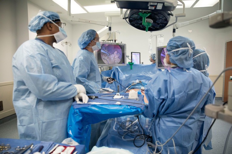 A surgeon performs gastric bypass surgery laparoscopically, using monitors to guide him