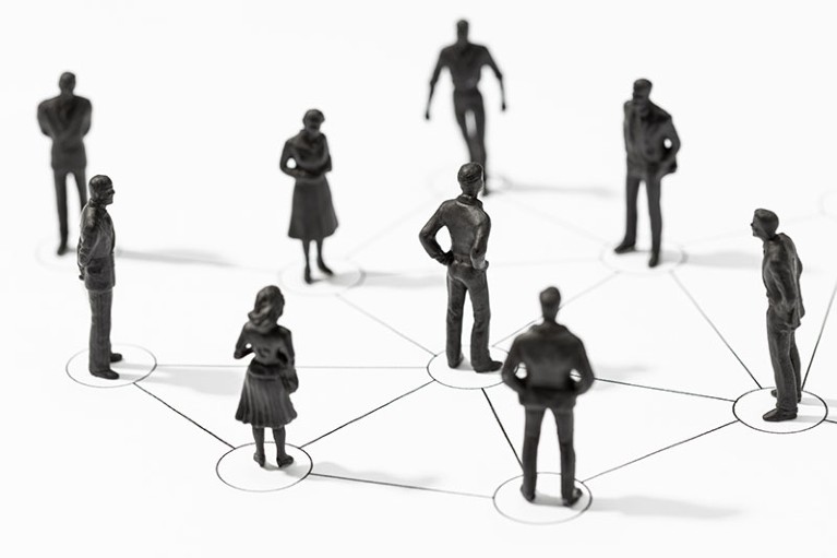 A group of figurines linked by lines illustrating a network of connected people.