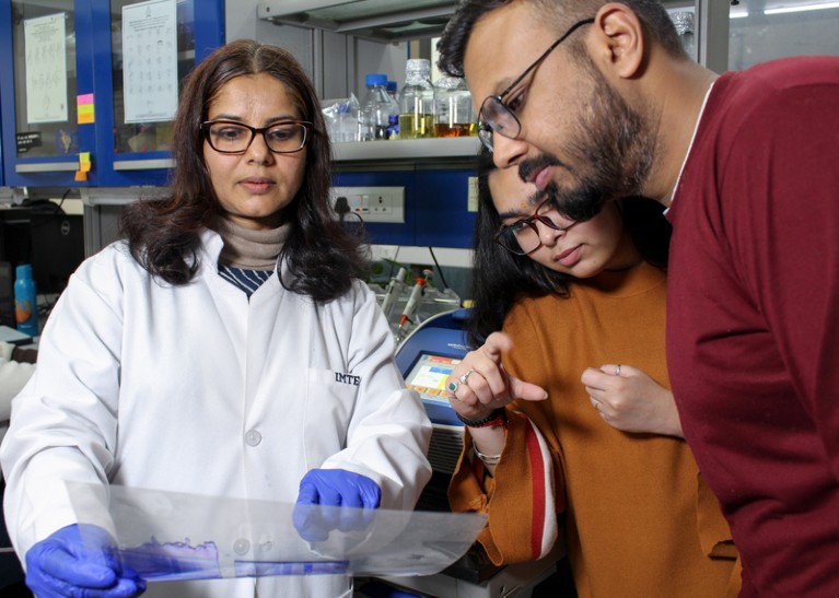 Alka Rao and Digvijay Singh look at a protein puzzle in the lab