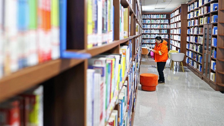 A deputy to the 13th National People's Congress reads at the library of University of Science and Technology Liaoning in Anshan.