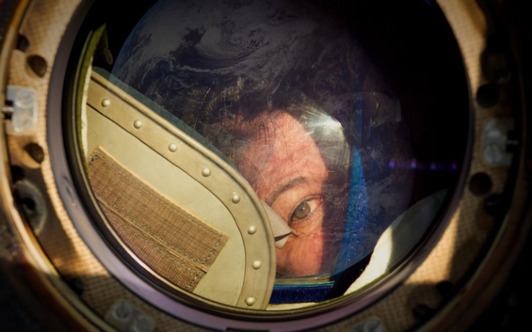 Cady Coleman looking out of the Soyuz.