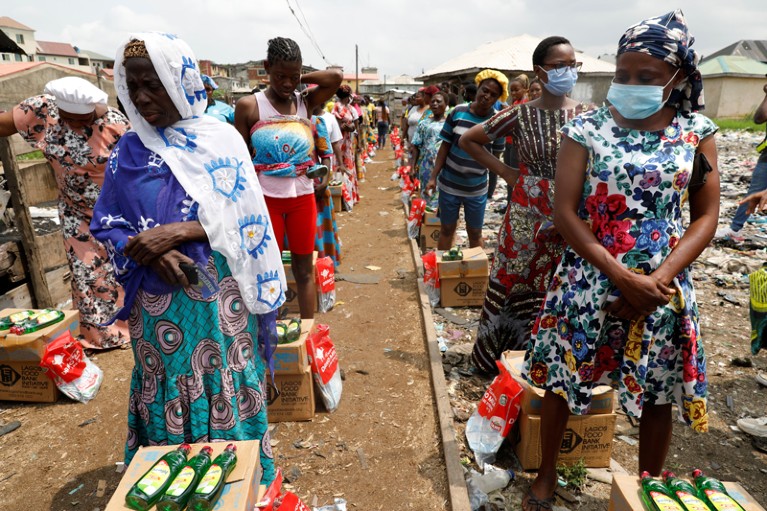 Rows of women queue for food parcels in Lagos, Nigeria