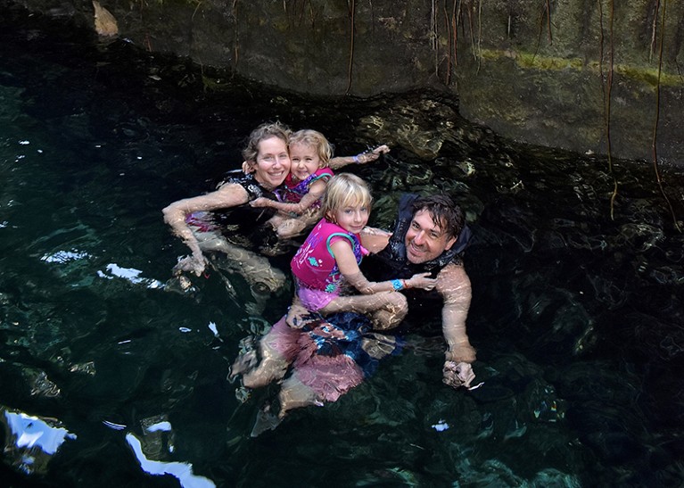 Lindsey Smith Taillie swimming in a cenote in Merida, Mexico, on December 2023 with her husband and two children.