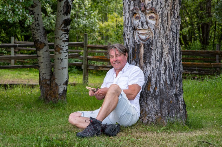 Portrait of Michael Blackstock sat at the base of a tree