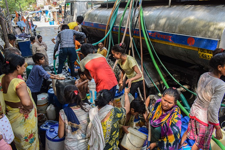 People fill water containers with drinking water from a tanker in New Delhi, India, as heatwaves increased demand for water.
