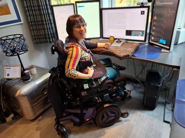 Claire Malone sitting at her home computer