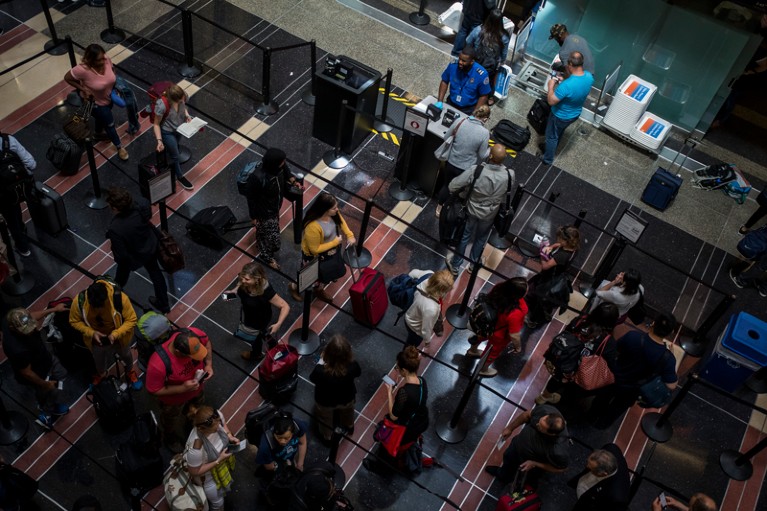 Aerial view of people waiting in line to go through a security checkpoint at Ronald Reagan National Airport