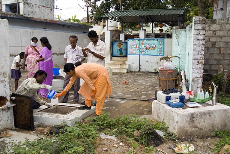 A group of environmental engineers take water samples from public toilets in a village in Tamil Nadu, India.