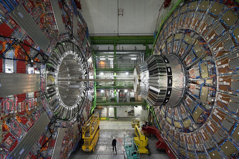 Person standing beneath large equipment at the European Organisation for Nuclear Research