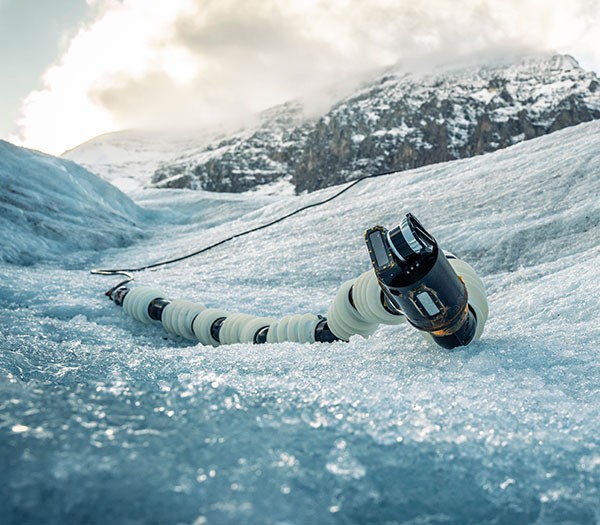 Version 1.0 of JPL’s EELS robot raises its head from the icy surface of Athabasca Glacier in Alberta, Canada, during field testing in September 2023.