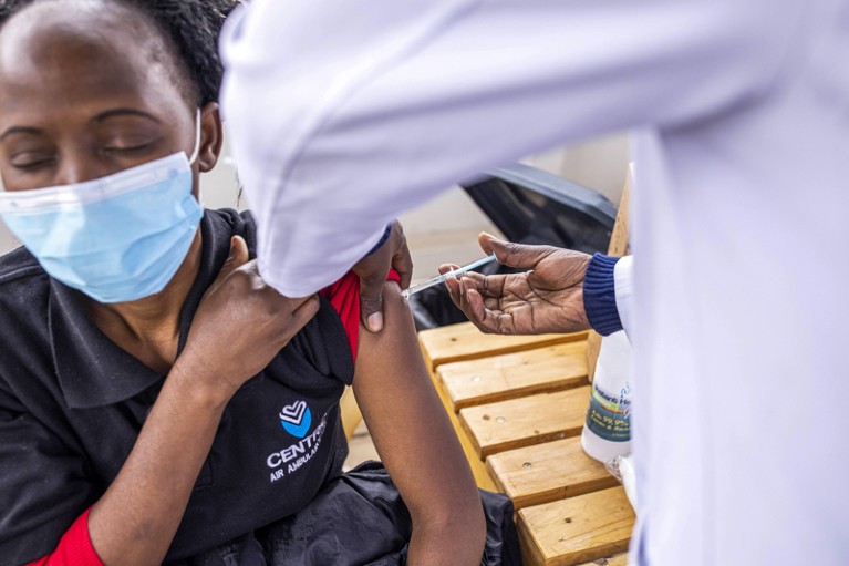 A resident wearing a face mask receives a dose of the Covid-19 vaccine in Kenya