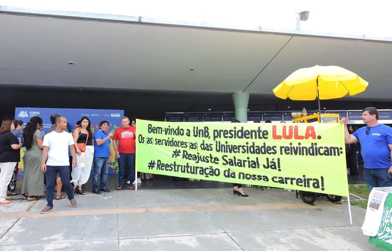 Protesters with a large banner outisde the National Education Conference at the University of Brasilia.