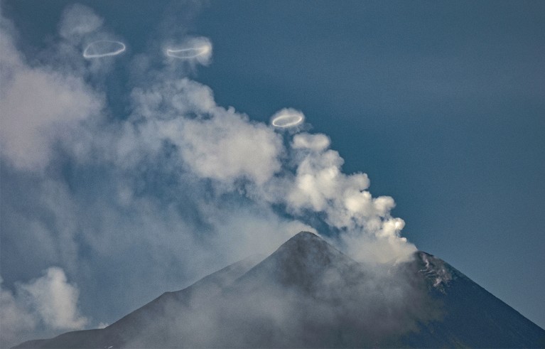 Smoke rings come out from the south-east crater of Etna volcano, Sicily.