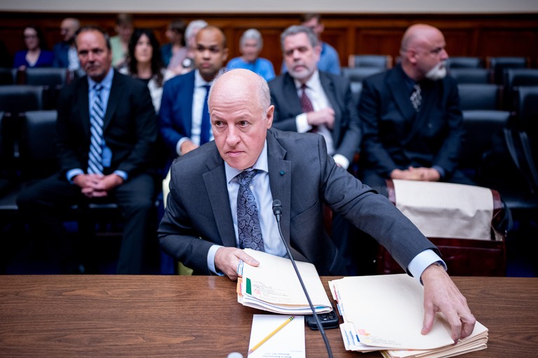Peter Daszak with papers at a desk in front of the House Select Subcommittee regarding the Coronavirus Pandemic.