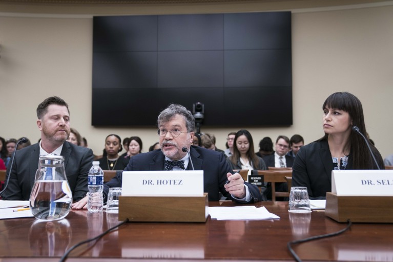 Peter Hotez speaks during a hearing with Tara Kirk Sell sitting next to him