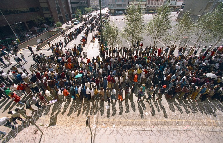 Long line of people waiting to cast their vote in South Africa first election in 1994.