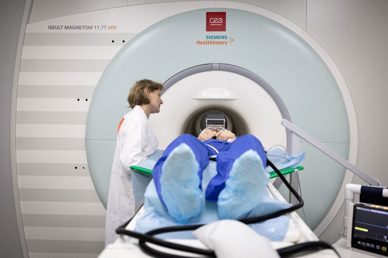 A person is helped into an MRI machine