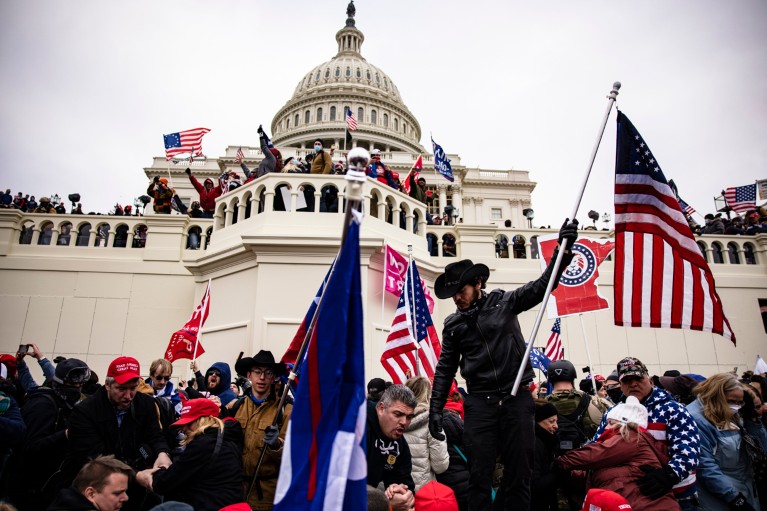 Close-up of pro-Trump supporters waving flags just outside the US Capitol