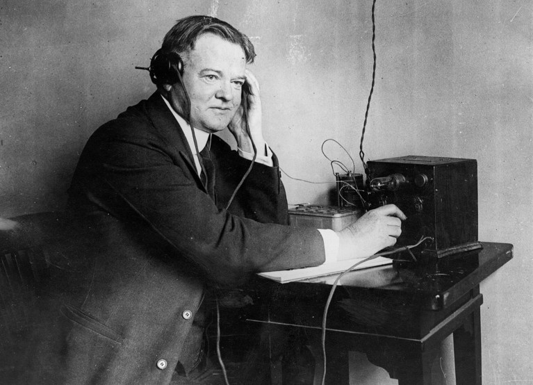 U.S. President Herbert Hoover listening to a one valve radio set in 1928.