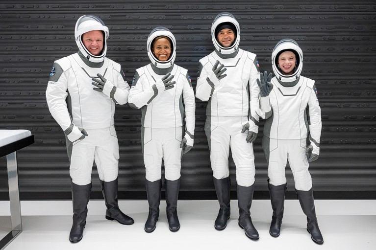 Four astronauts in new suits for use in space.