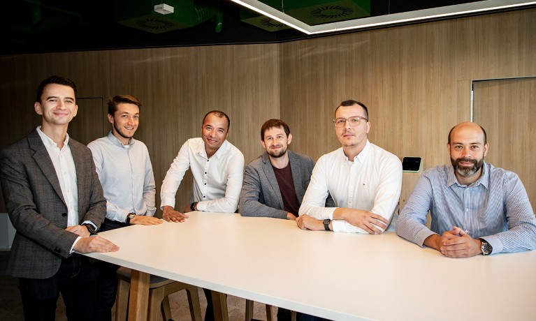 Group of six men in the office. The Data Science and Analytics leadership team from Żabka Group, captured during a professional session. Tomasz Głowacki, first on the right, is a member of this team.