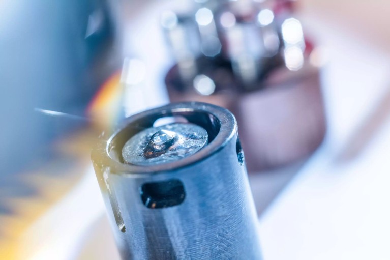 Close up on part of a stamp cell used to put materials under high pressure using synthetic diamond tips