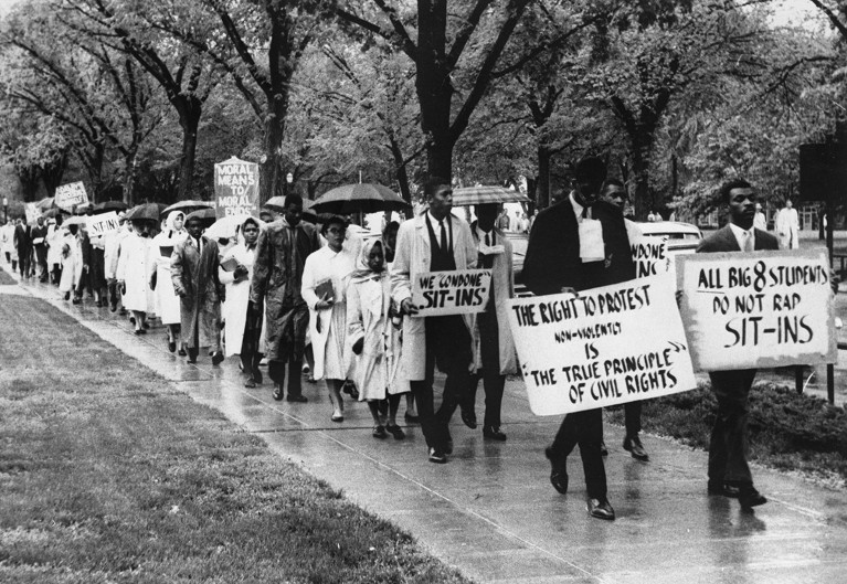 Black students marched through the Kansas University campus in the rain holding signs to support civil rights in the 1960s.