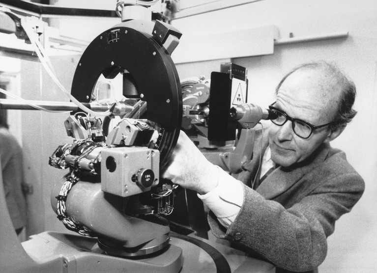 Max Perutz operating an X-ray crystal machine.