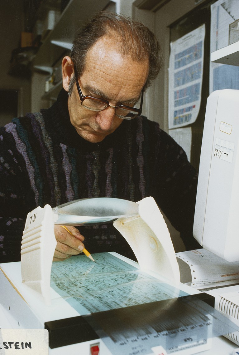 César Milstein viewing anautorad output at a machine.