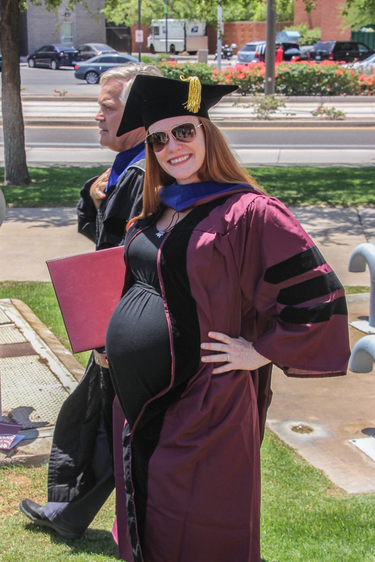 Wendy Bohon wearing a graduation cap and gown whilst visibly pregnant