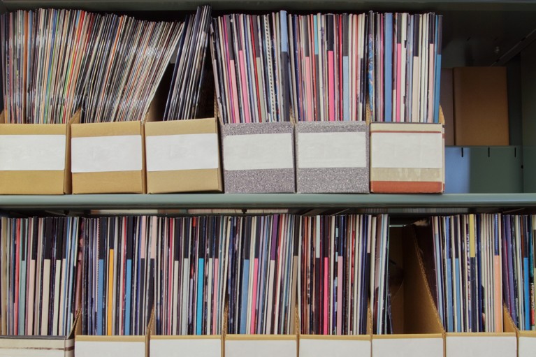 Scientific journals in cardboard magazine holders on bookshelves.