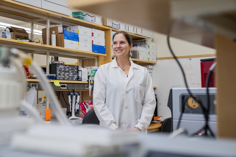 Anne Wyllie smiles into the distance in a laboratory