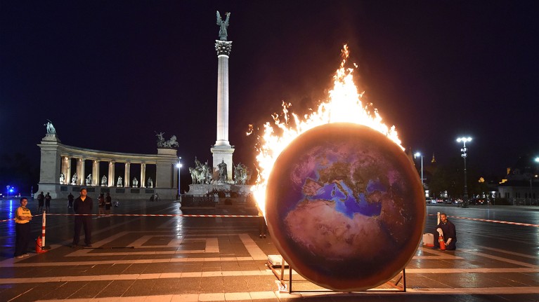 A model of the Earth on fire during a Greenpeace protest in Budapest, 2019.