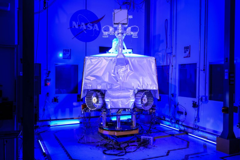 NASA's VIPER rover assembled in a clean room flooded with blue light