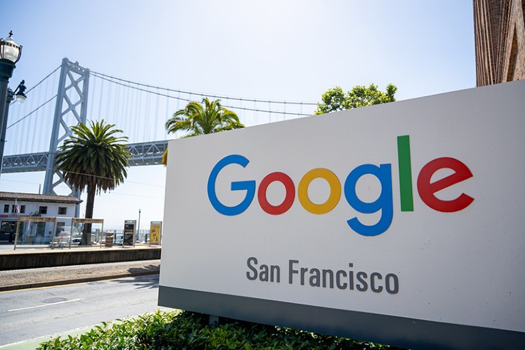 A sign that reads "Google San Francisco" stands in front of Bay Bridge