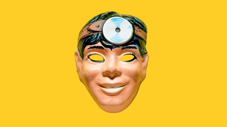 A plastic mask of the face of a doctor with black hair wearing a head mirror on a yellow background