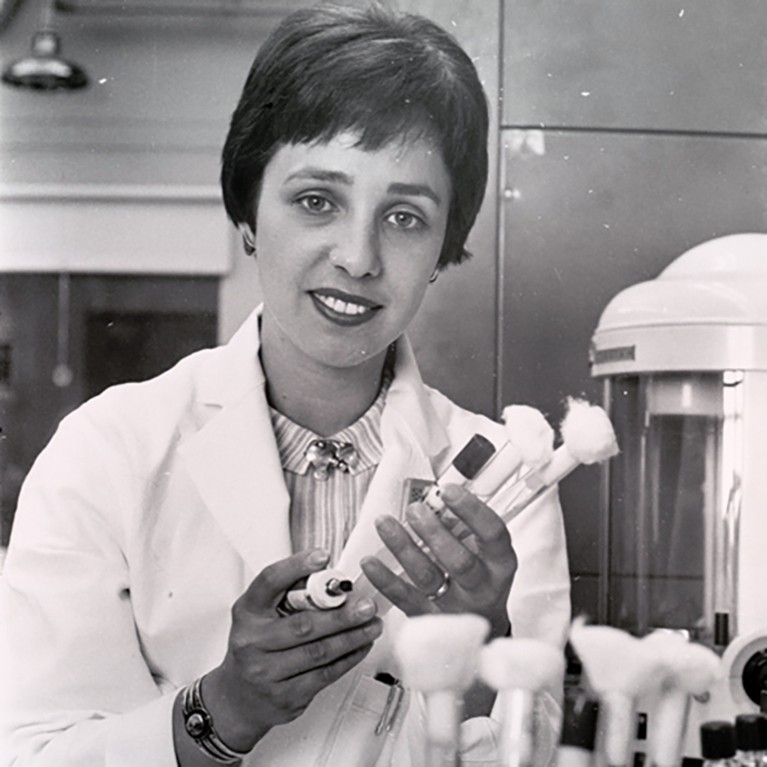 Maxine Frank Singer in the laboratory holding vials.