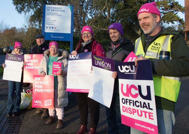 Brighton University staff working at the Universities Eastbourne site hold signs and strike for better conditions.