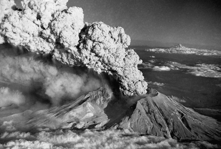 Black and white photograph of an ash plume billowing from the crater of Mount St Helens during the eruption in 1980