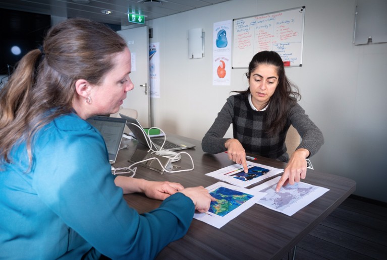 Solmaz Mohadjer looks at print-outs of geographical data with a school teacher as part of a project to engage students and improve learning