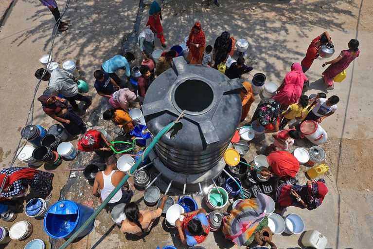 An aerial view of residents collecting drinking water from a tanker amid extreme hea in Jaipur, Rajasthan, India.